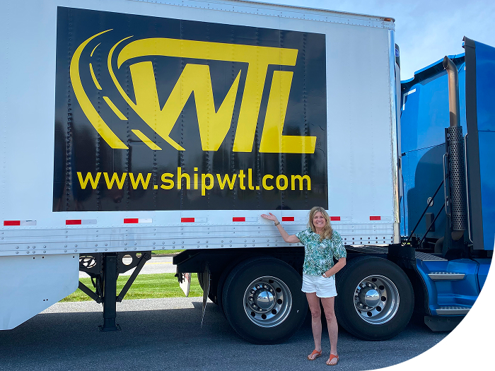 A woman standing in front go the WTL Truck